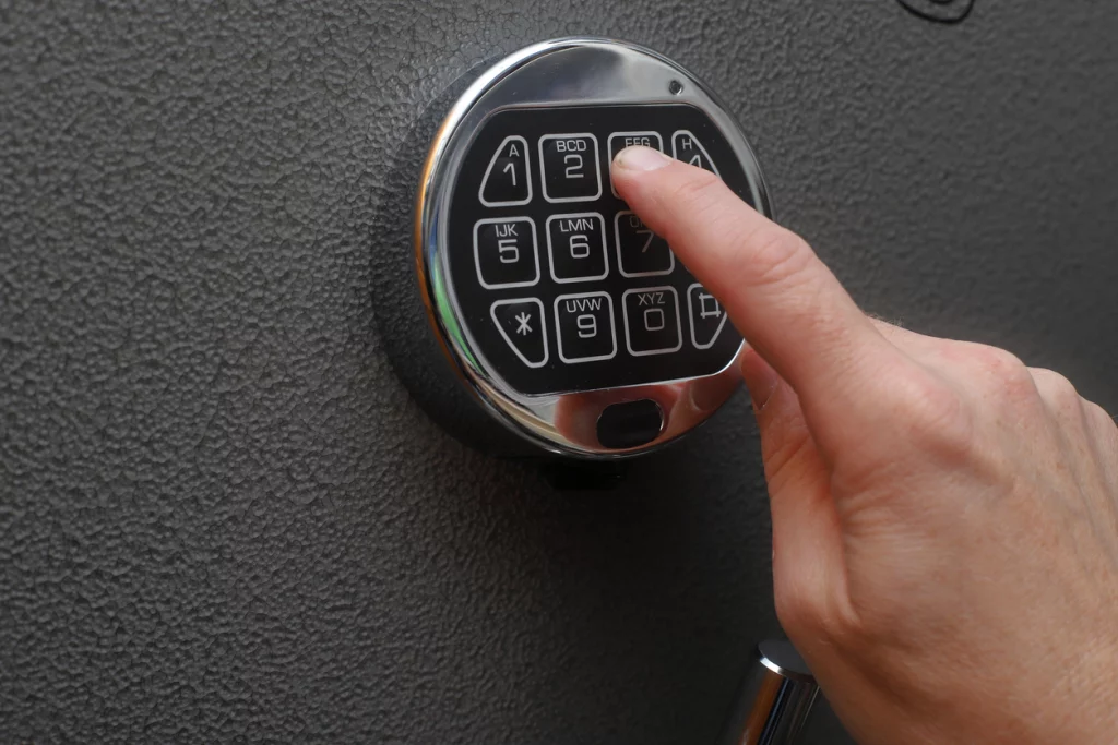 Hand enters combination on a digital lock of a gun safe door