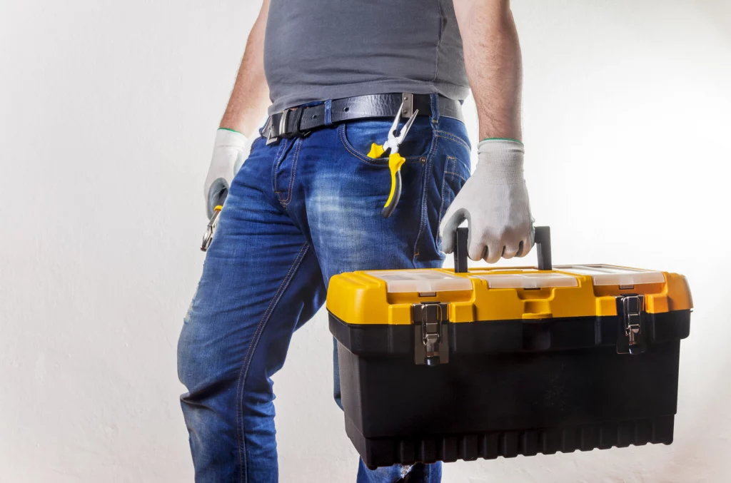 Repairman carrying toolbox