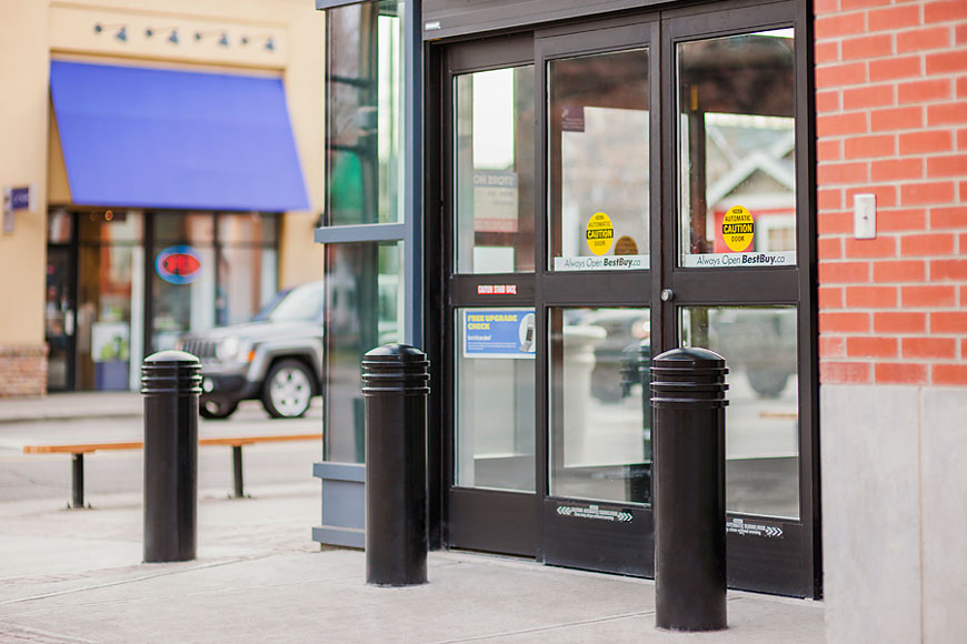 Security bollards with decorative metal covers over top in front of government building