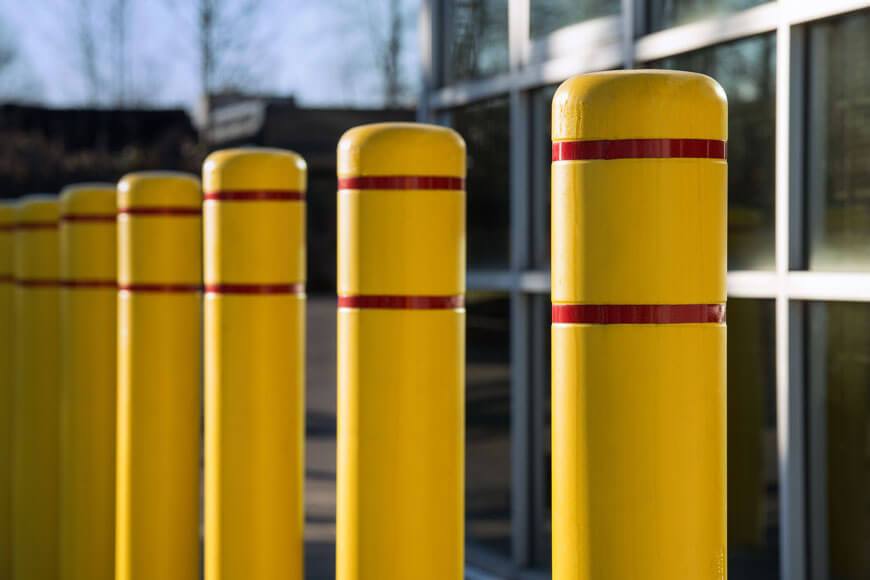 Yellow plastic bollards cover security bollards