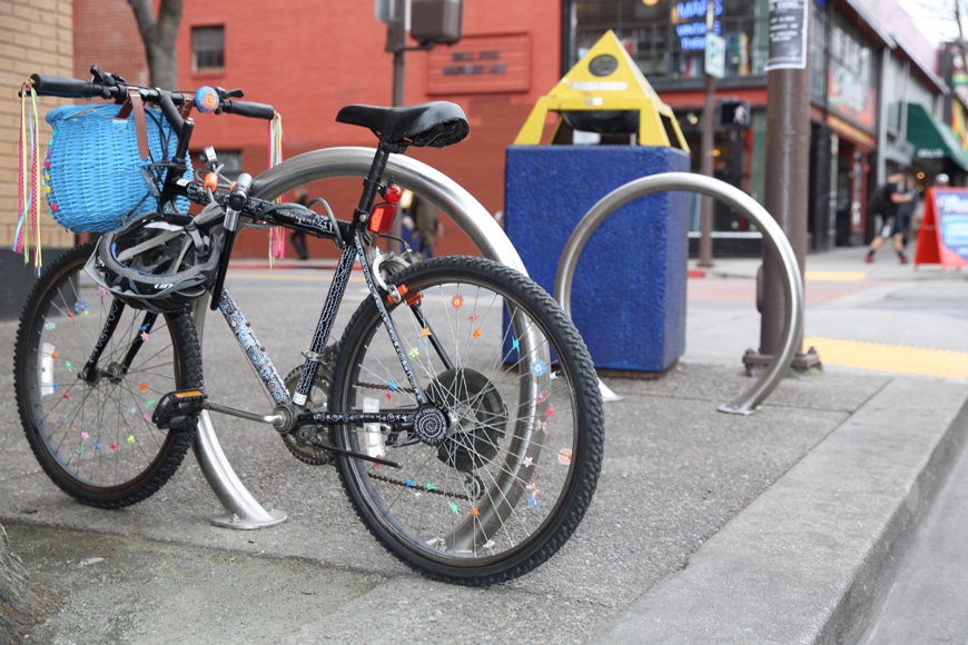 Un vélo décoré est verrouillé à un support à vélos à la fois avec un cadenas à chaîne et en U 