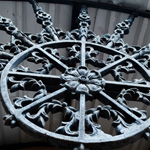 An ornate cast metal grille features a floral ornament