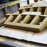 A sand core waits to be put in a mold where it will create space inside the final object