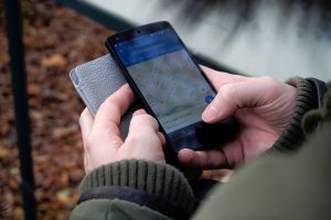 A person holding a phone with the Google Maps app open