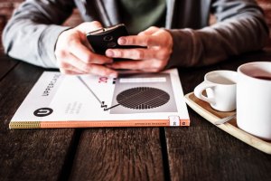 A person using a phone in a coffeeshop