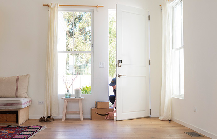 Key by Amazon delivery driver placing package inside front door with Schlage Encode lock