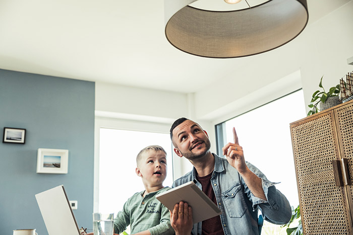 Father and son looking at smart light.